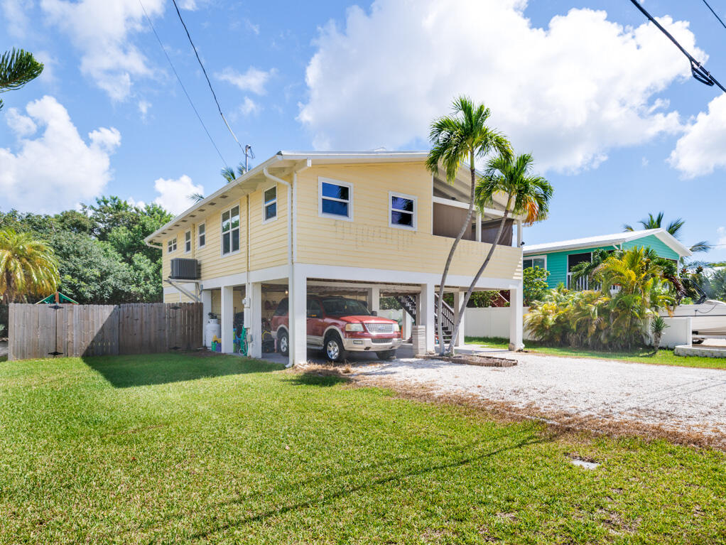 29283 Coconut Palm Drive Big Pine Key, FL 33043 - Photo 32 of 35 a front view of a house with garden