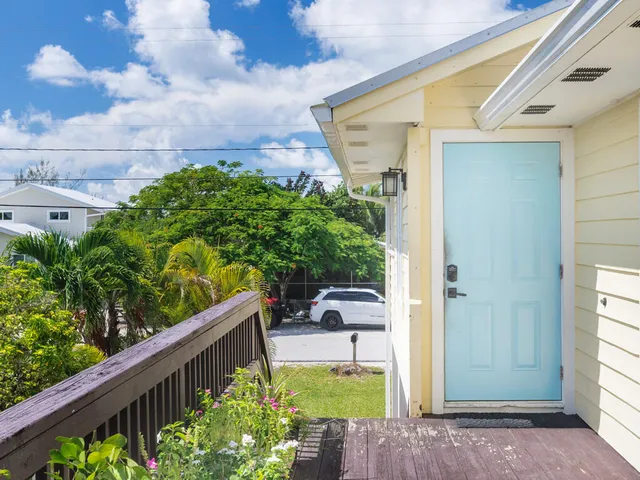 an aerial view of a house with a yard and potted plants