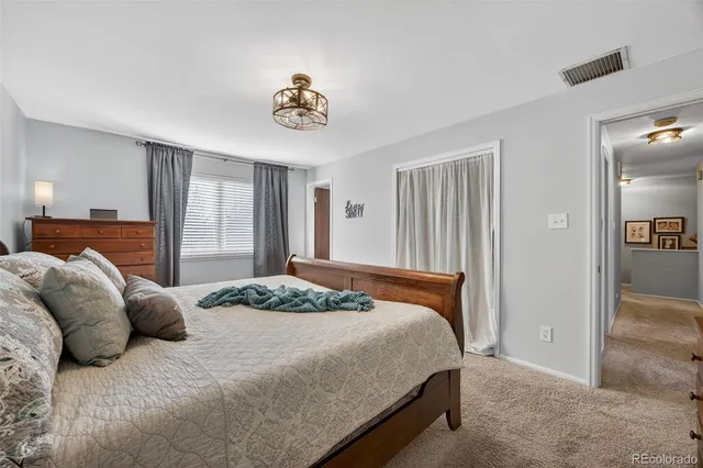 a bedroom with a large bed and a chandelier