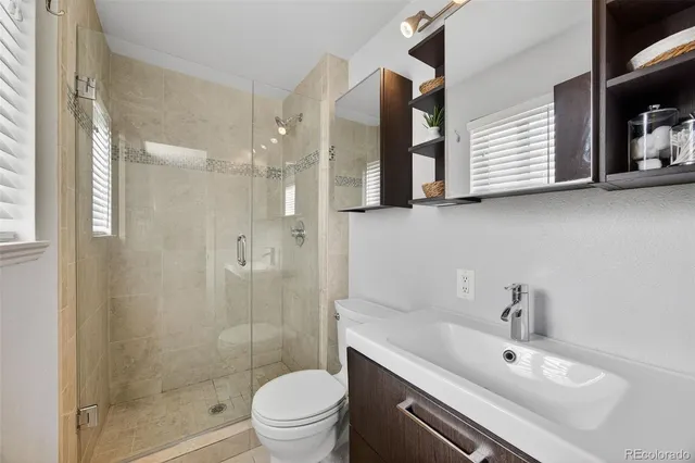 a bathroom with a sink toilet and shower