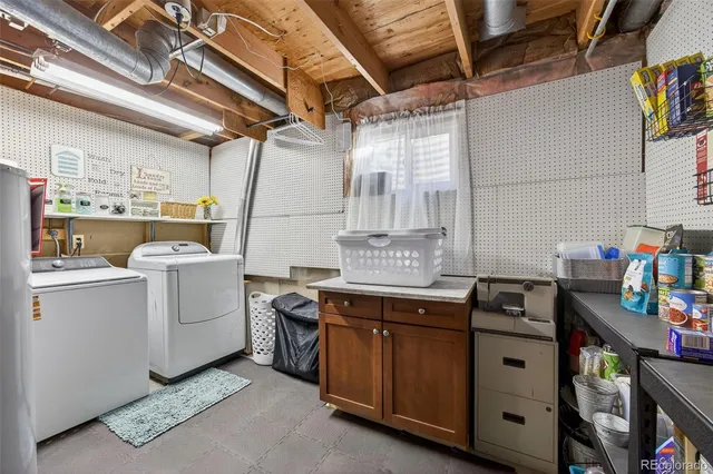 a utility room with cabinets dryer and washer