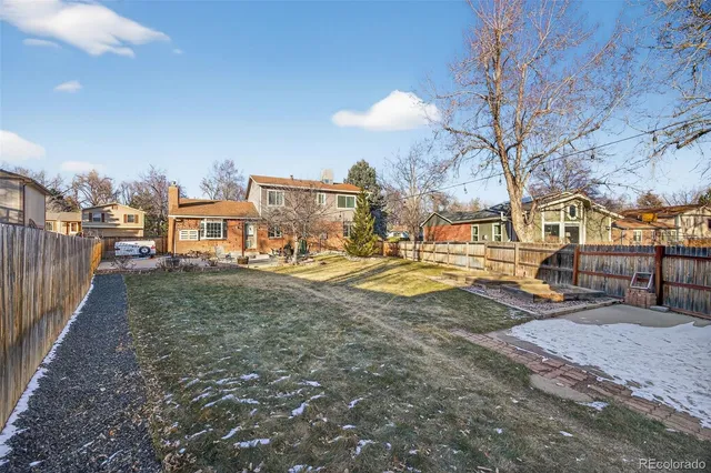 a view of a yard with cars
