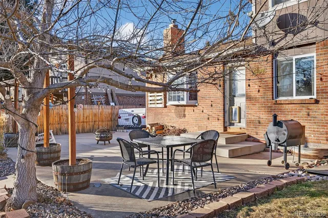 a view of a patio with a table and chairs