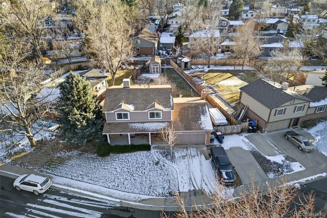 an aerial view of a house with a yard