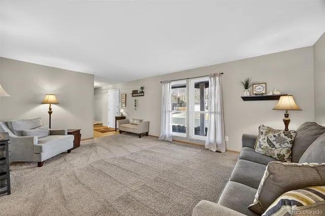 a living room with furniture and a lamp