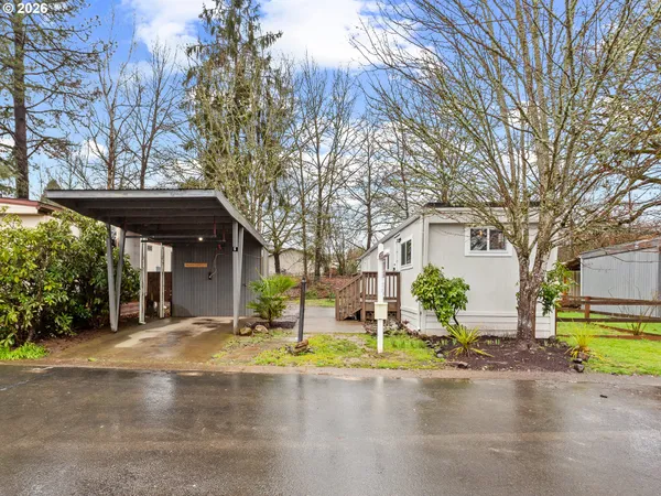 a front view of house with yard and trees around