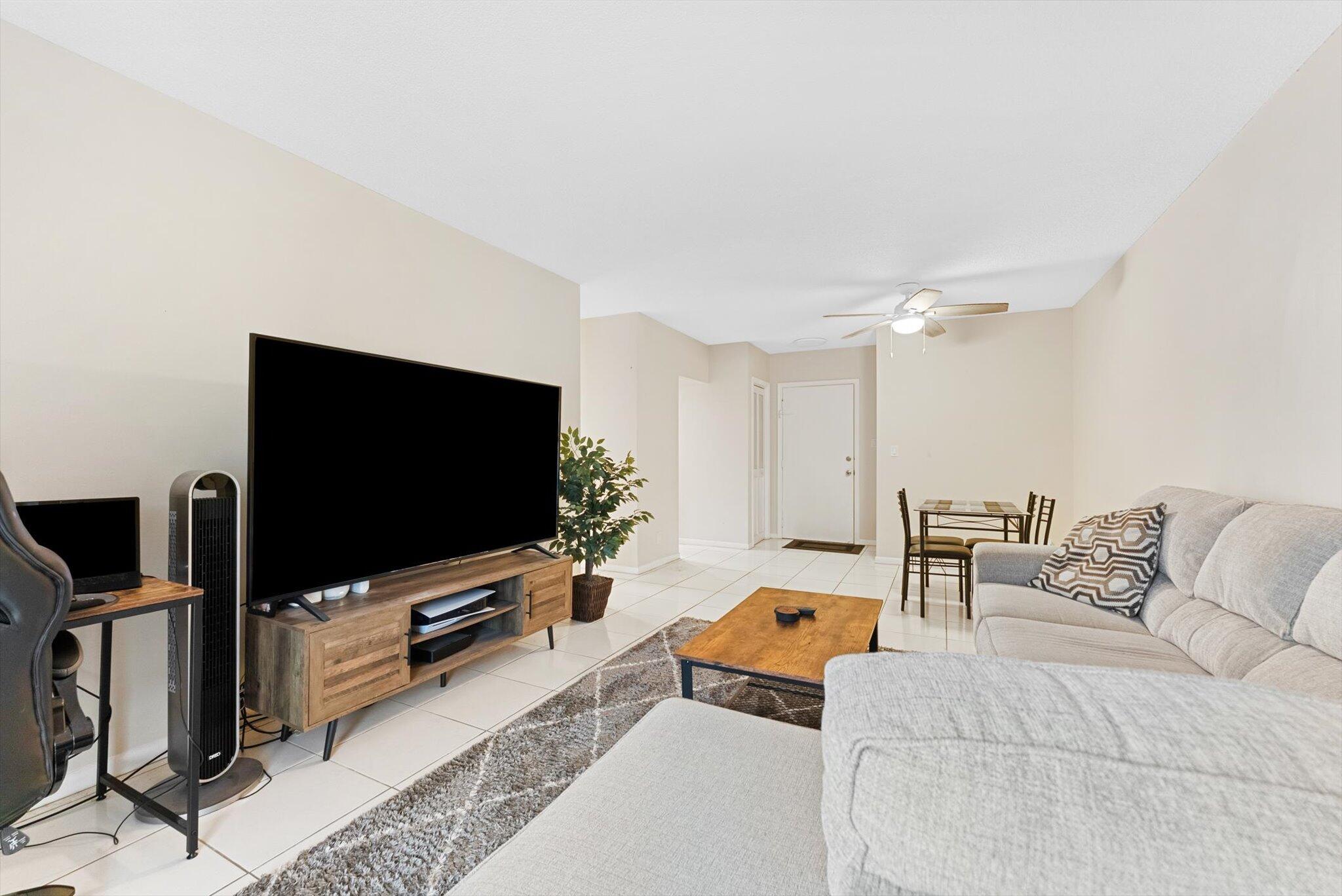 200 South Birch Road, Unit 204 Fort Lauderdale, FL 33316 - Photo 2 of 21 a living room with furniture and a flat screen tv
