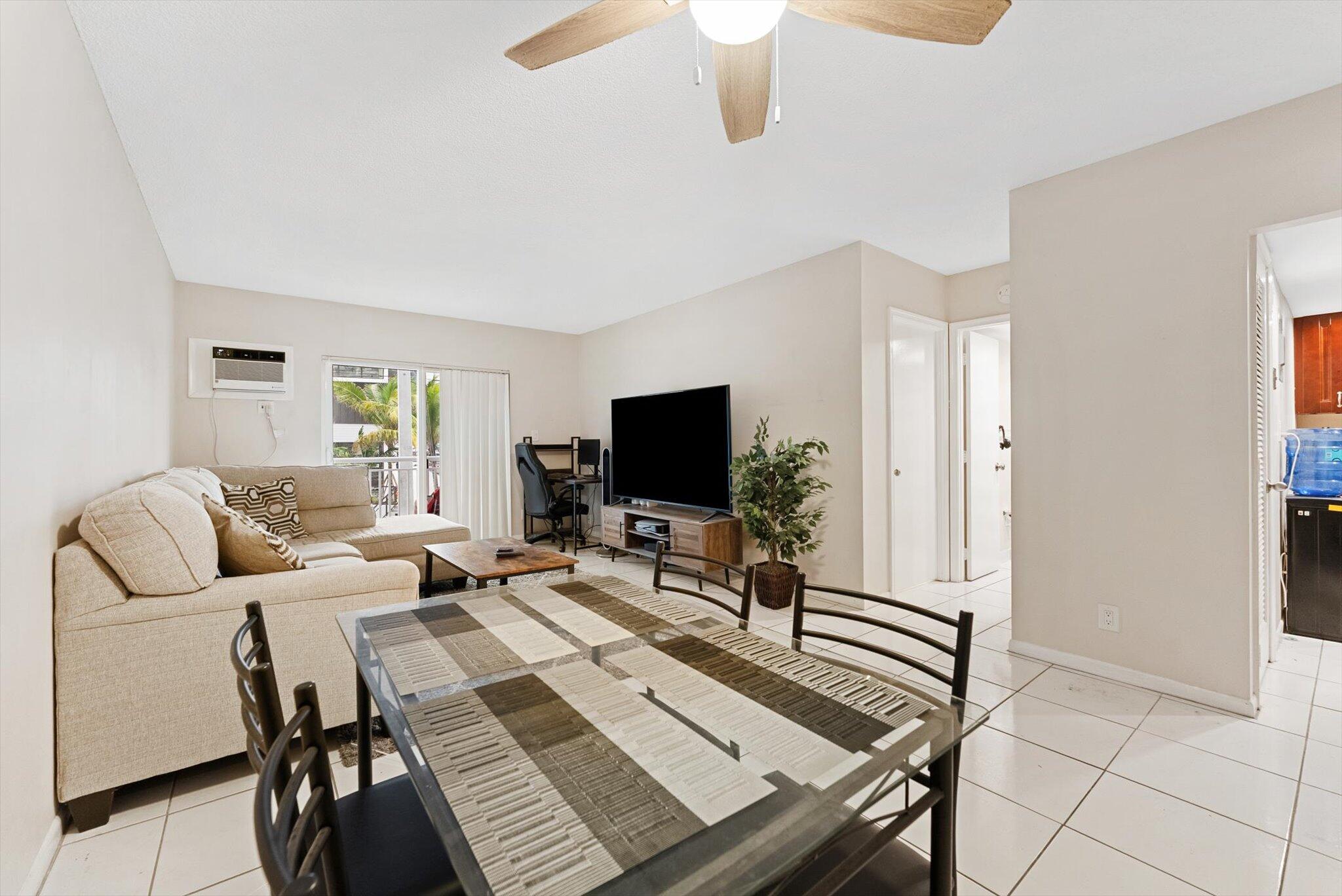 200 South Birch Road, Unit 204 Fort Lauderdale, FL 33316 - Photo 4 of 21 a living room with furniture and a flat screen tv