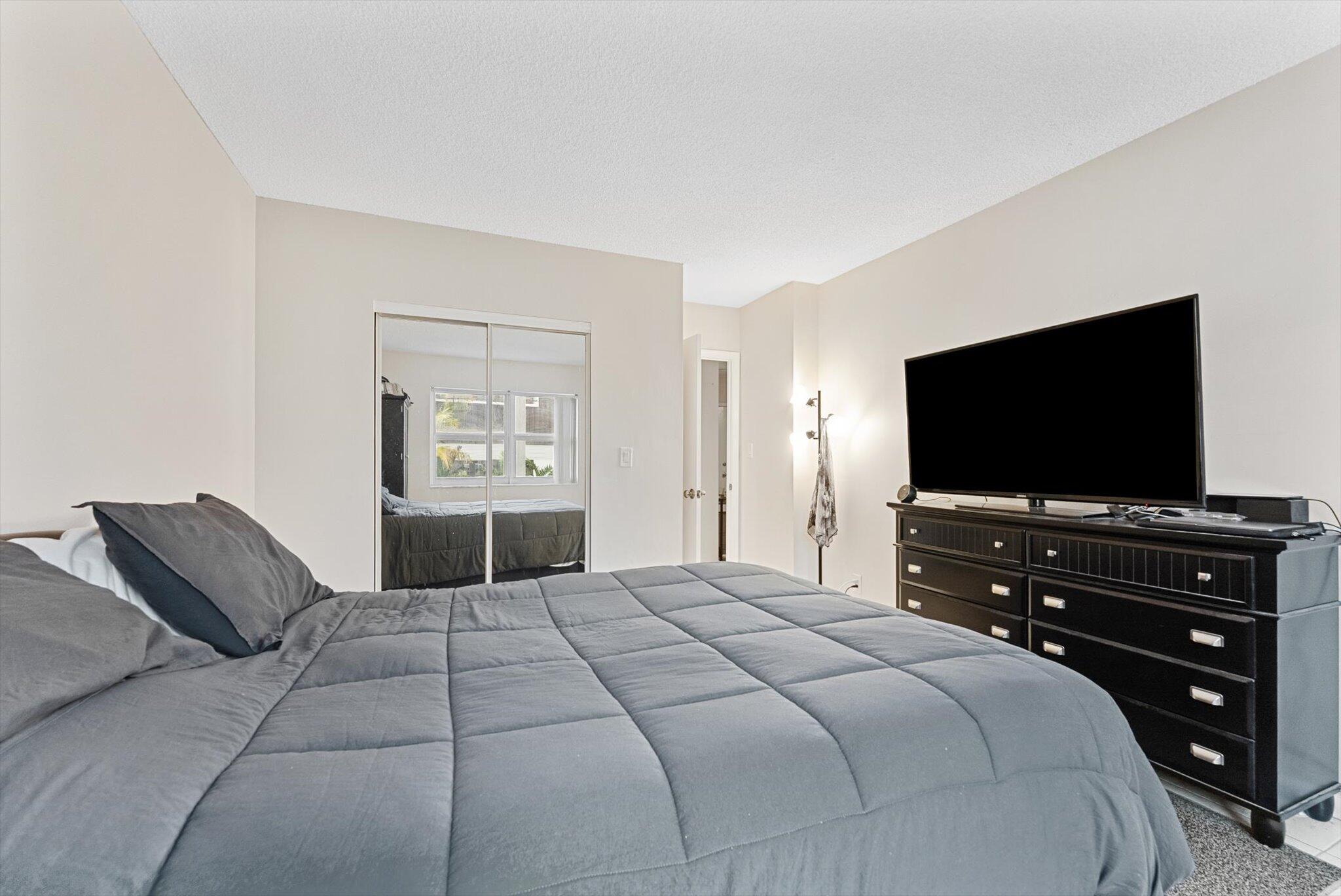 200 South Birch Road, Unit 204 Fort Lauderdale, FL 33316 - Photo 8 of 21 a bedroom with a bed and a flat screen tv