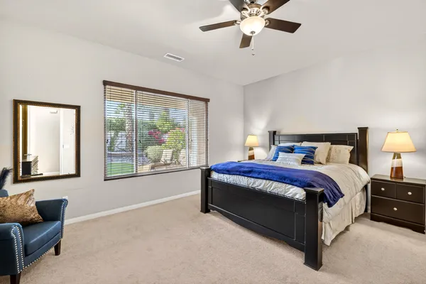 a spacious bedroom with a bed and a couch