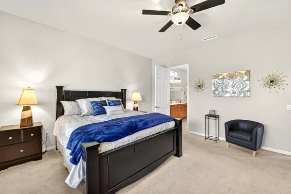 a bed room with a bed and a chandelier