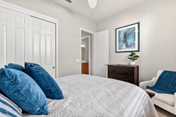 a bedroom with a bed and a cabinet