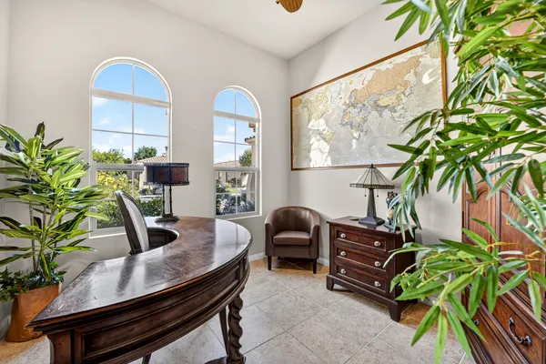 a dining room with furniture and a potted plant