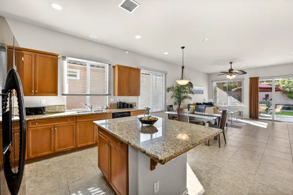 a kitchen with sink a stove and chairs