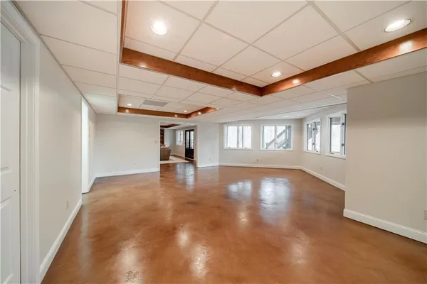 a living room with furniture a table and a pool table