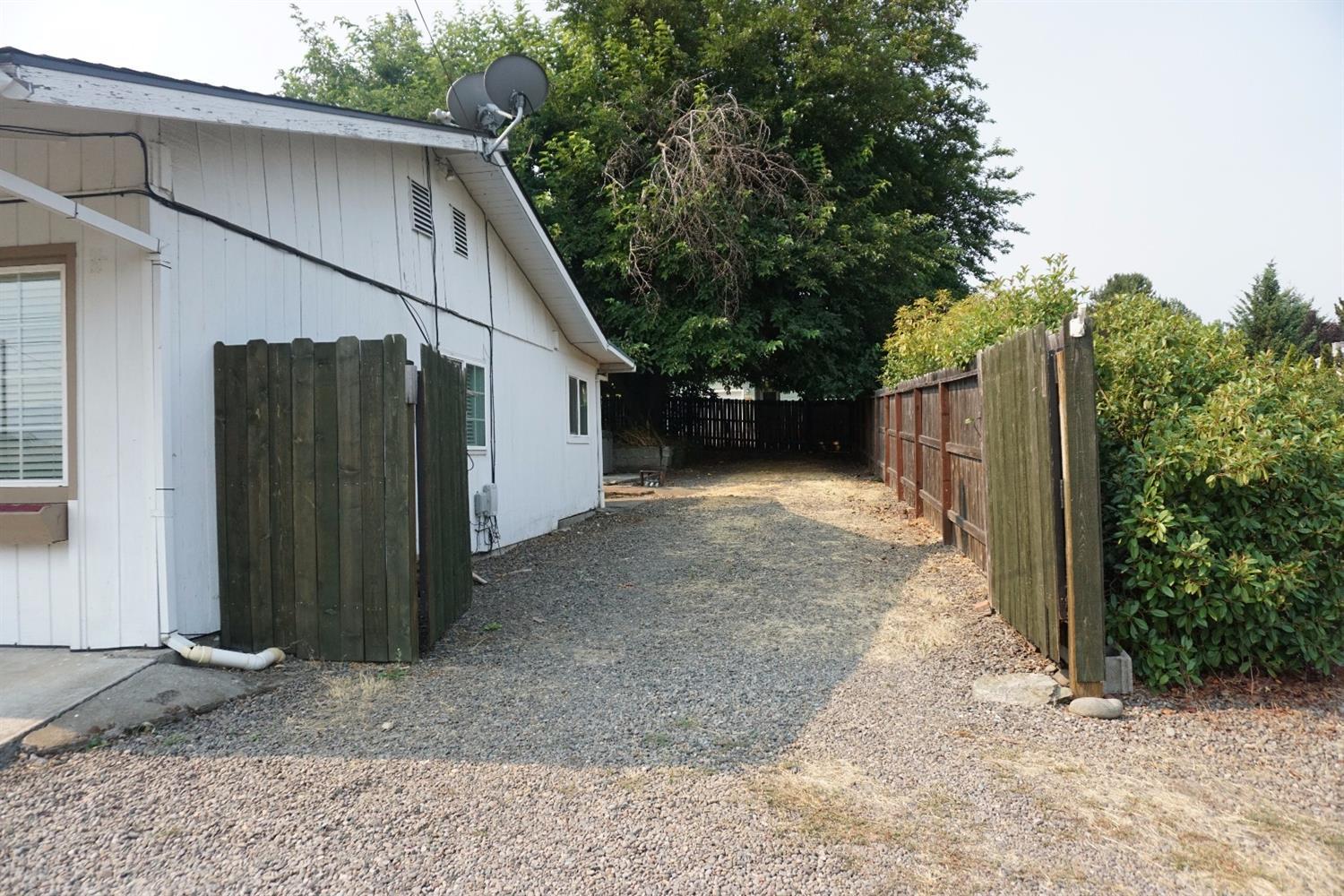 1312 Talent Avenue Talent, OR 97540 - Photo 3 of 21 a view of a house with a backyard and garage