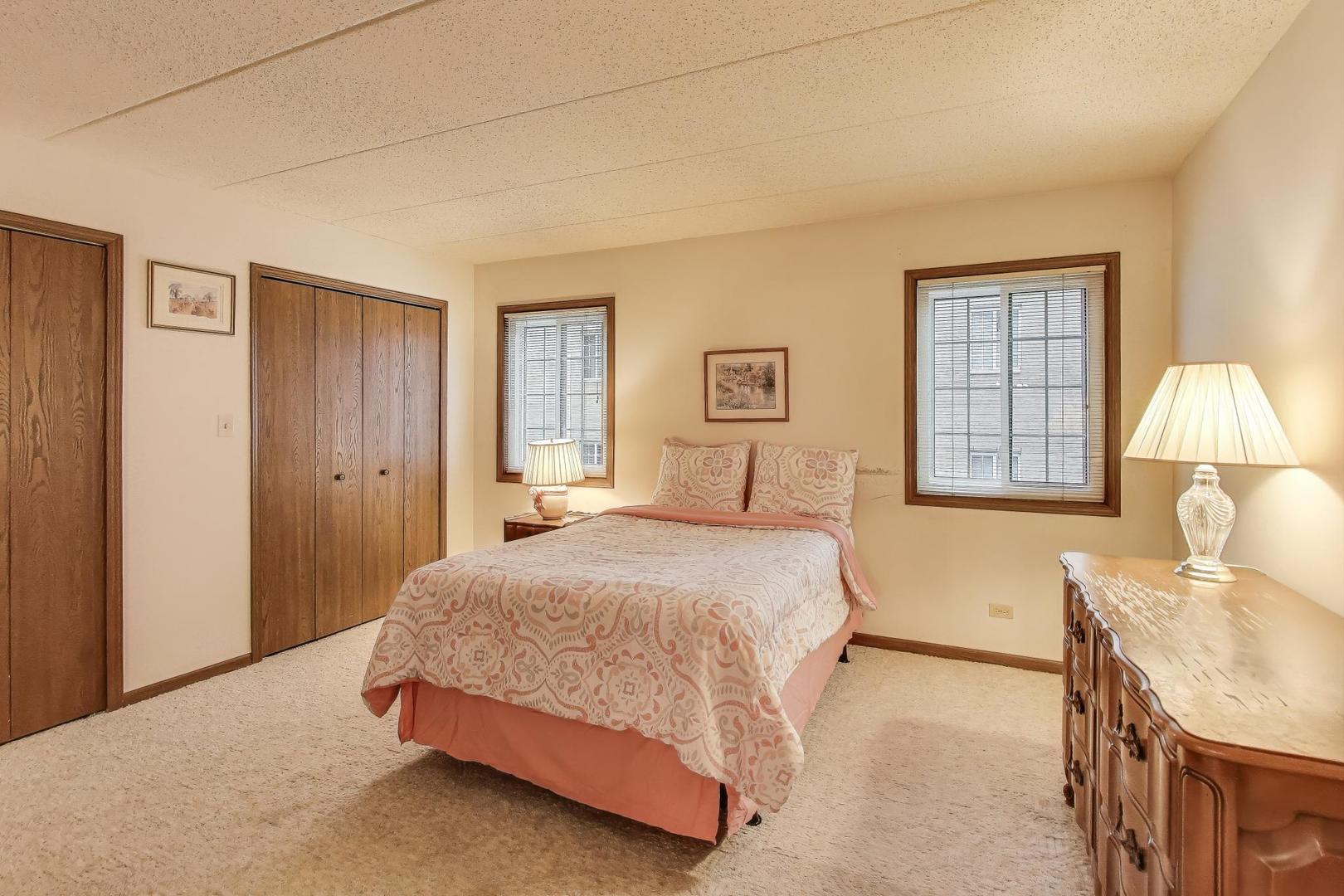 462 South President Street, Unit 202 Carol Stream, IL 60188 - Photo 13 of 26 a spacious bedroom with a bed a table and dresser