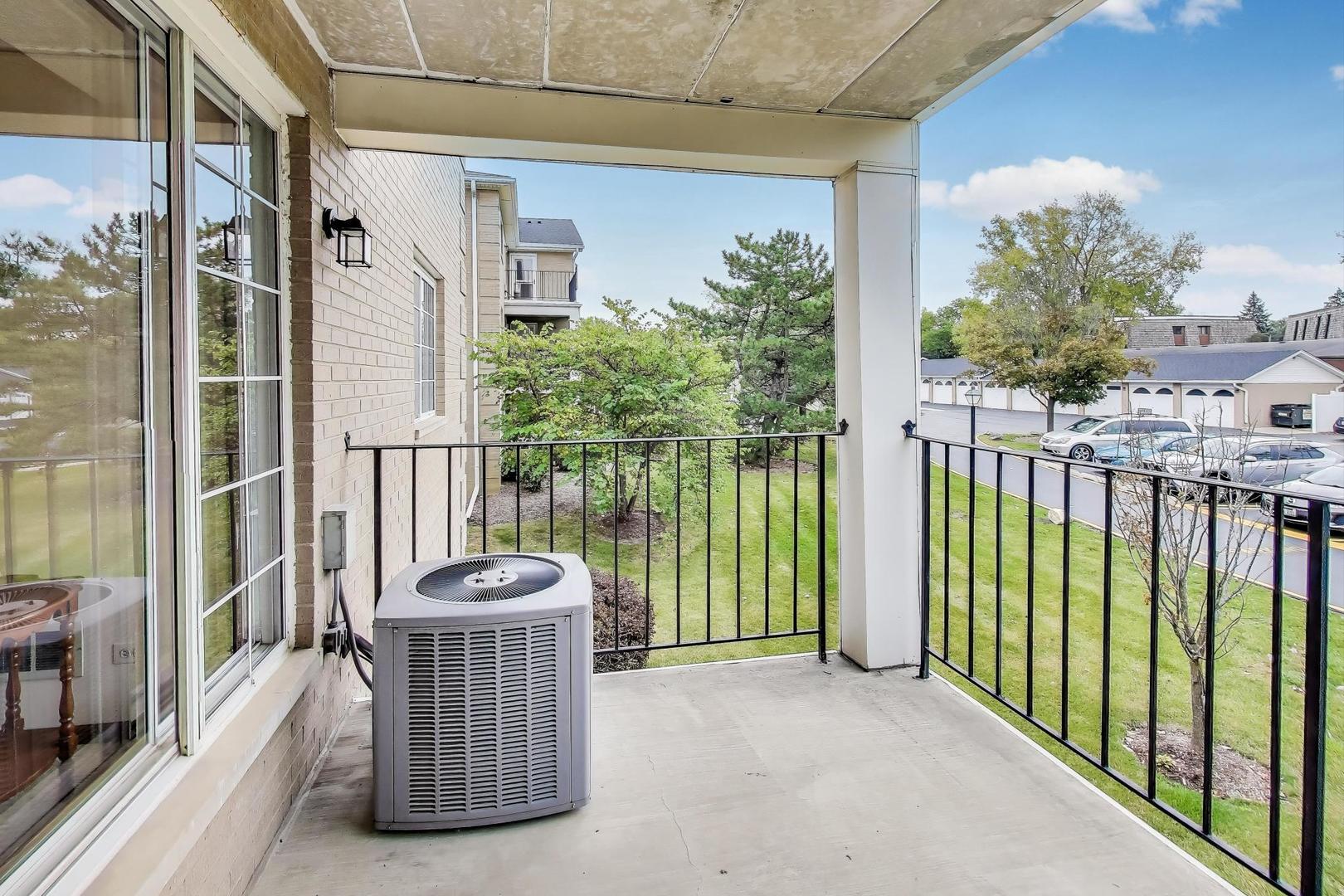 462 South President Street, Unit 202 Carol Stream, IL 60188 - Photo 22 of 26 a view of a balcony with floor to ceiling window and wooden fence