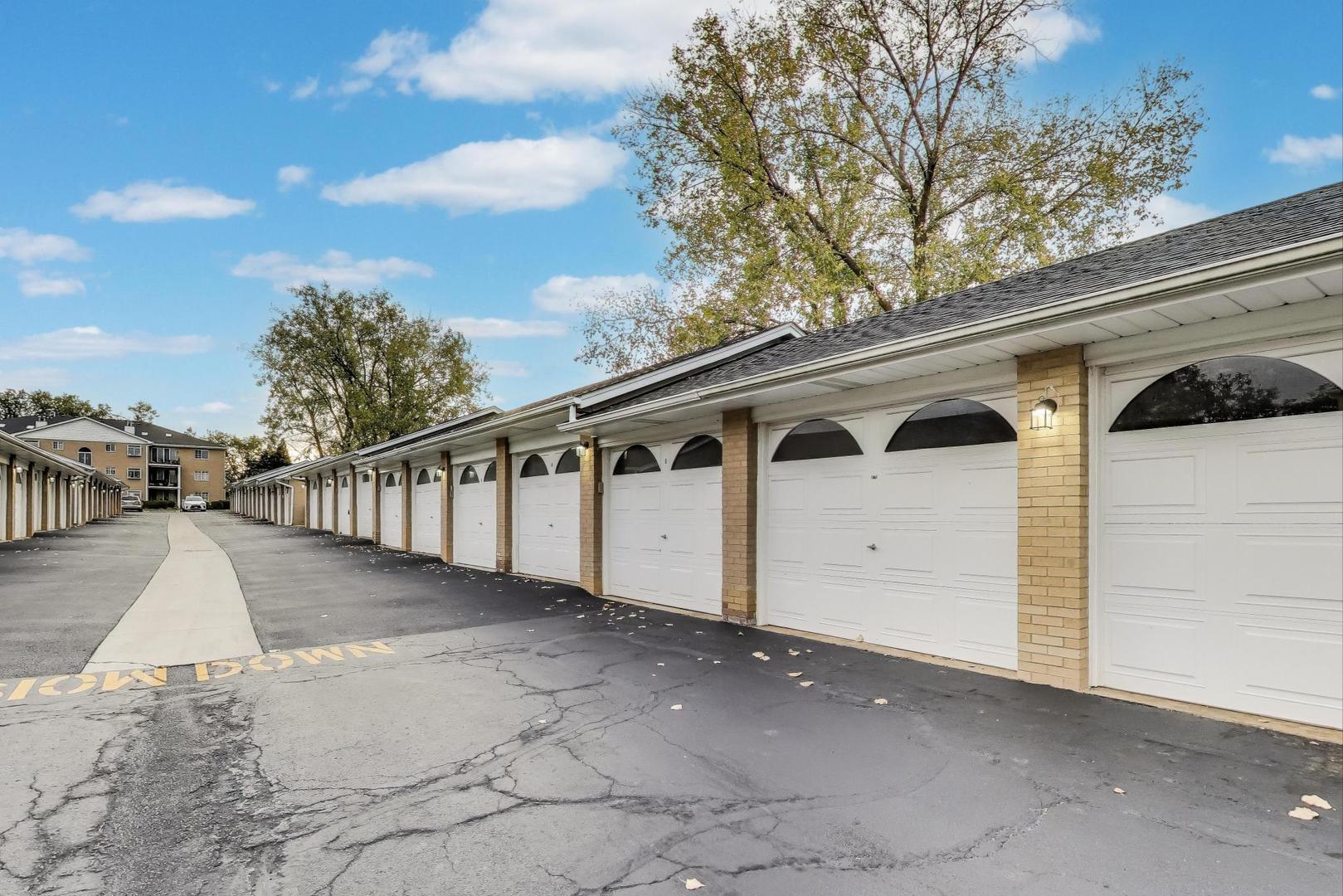 462 South President Street, Unit 202 Carol Stream, IL 60188 - Photo 23 of 26 a view of a white house with wooden fence
