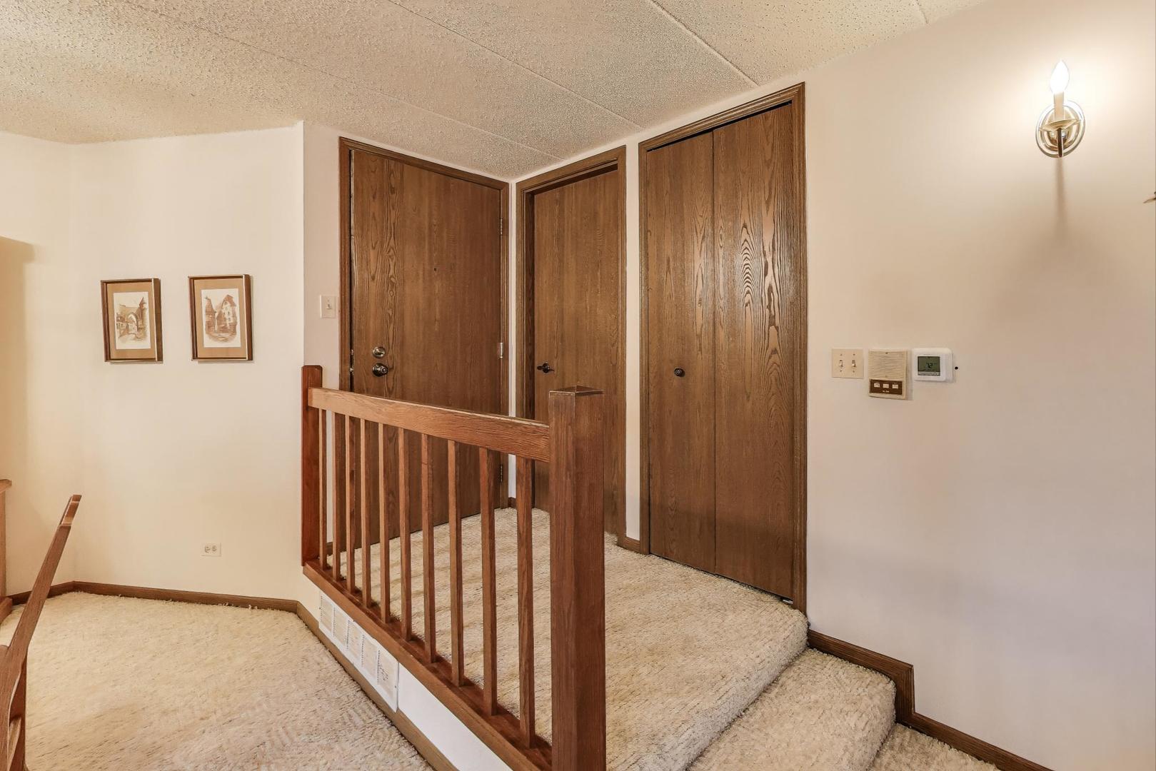 462 South President Street, Unit 202 Carol Stream, IL 60188 - Photo 3 of 26 a view of a hallway with wooden floor