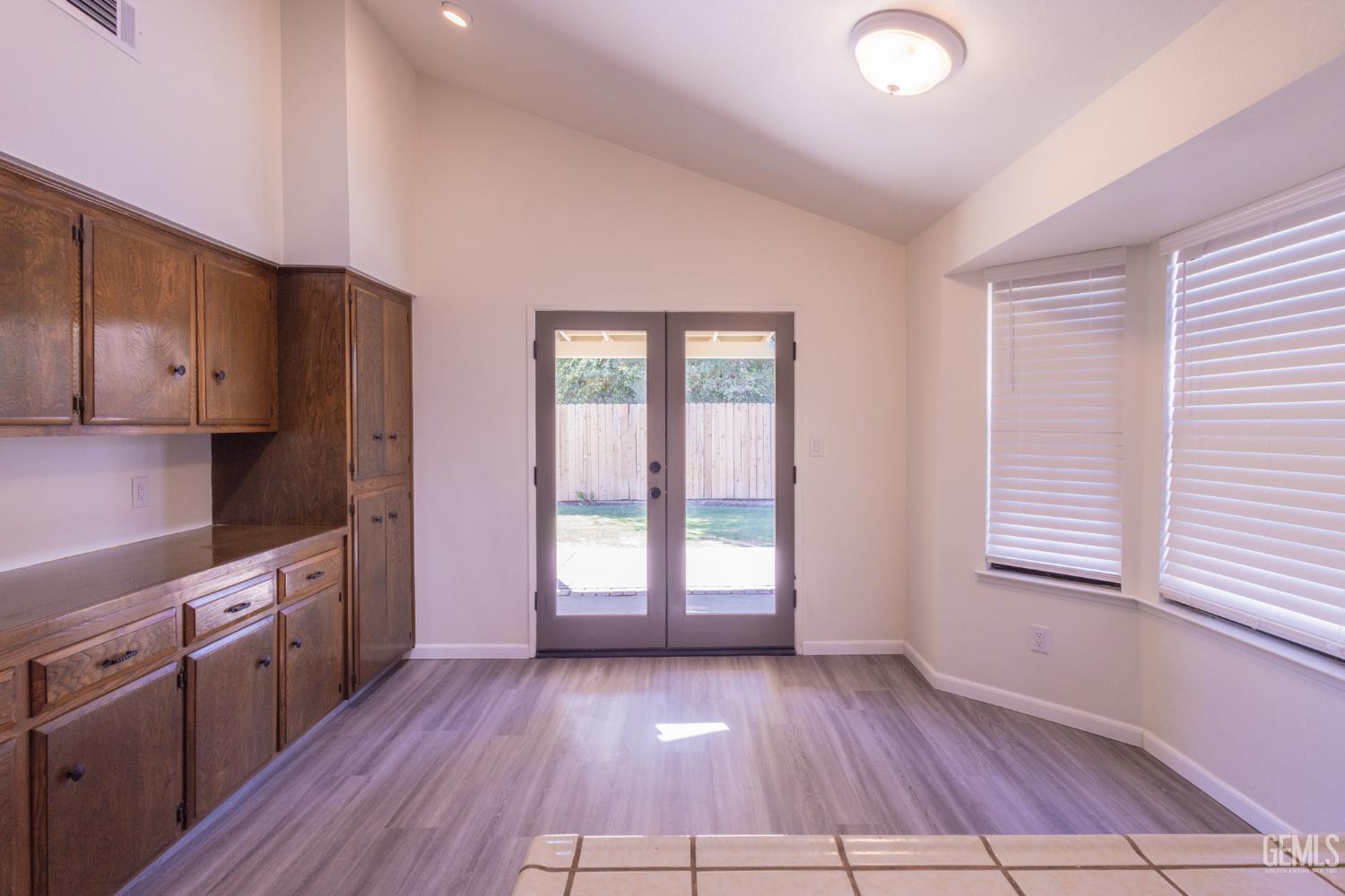 Undisclosed Address Bakersfield, CA 93309 - Photo 11 of 37 a view of a kitchen with wooden floor and electronic appliances