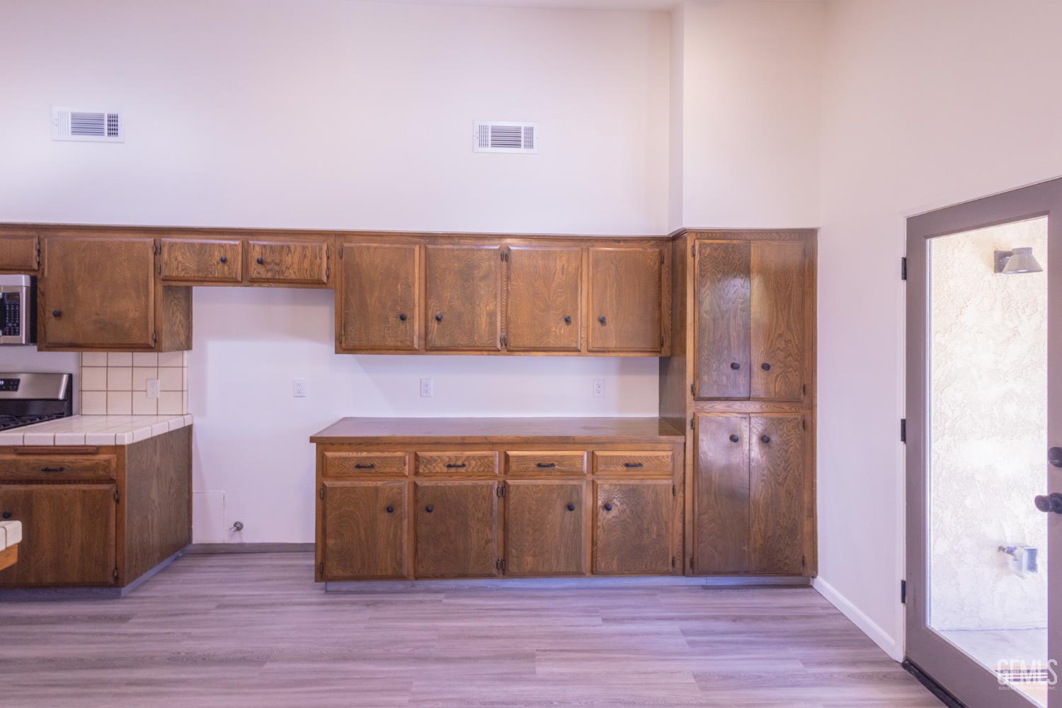 Undisclosed Address Bakersfield, CA 93309 - Photo 13 of 37 a view of a kitchen with wooden floor