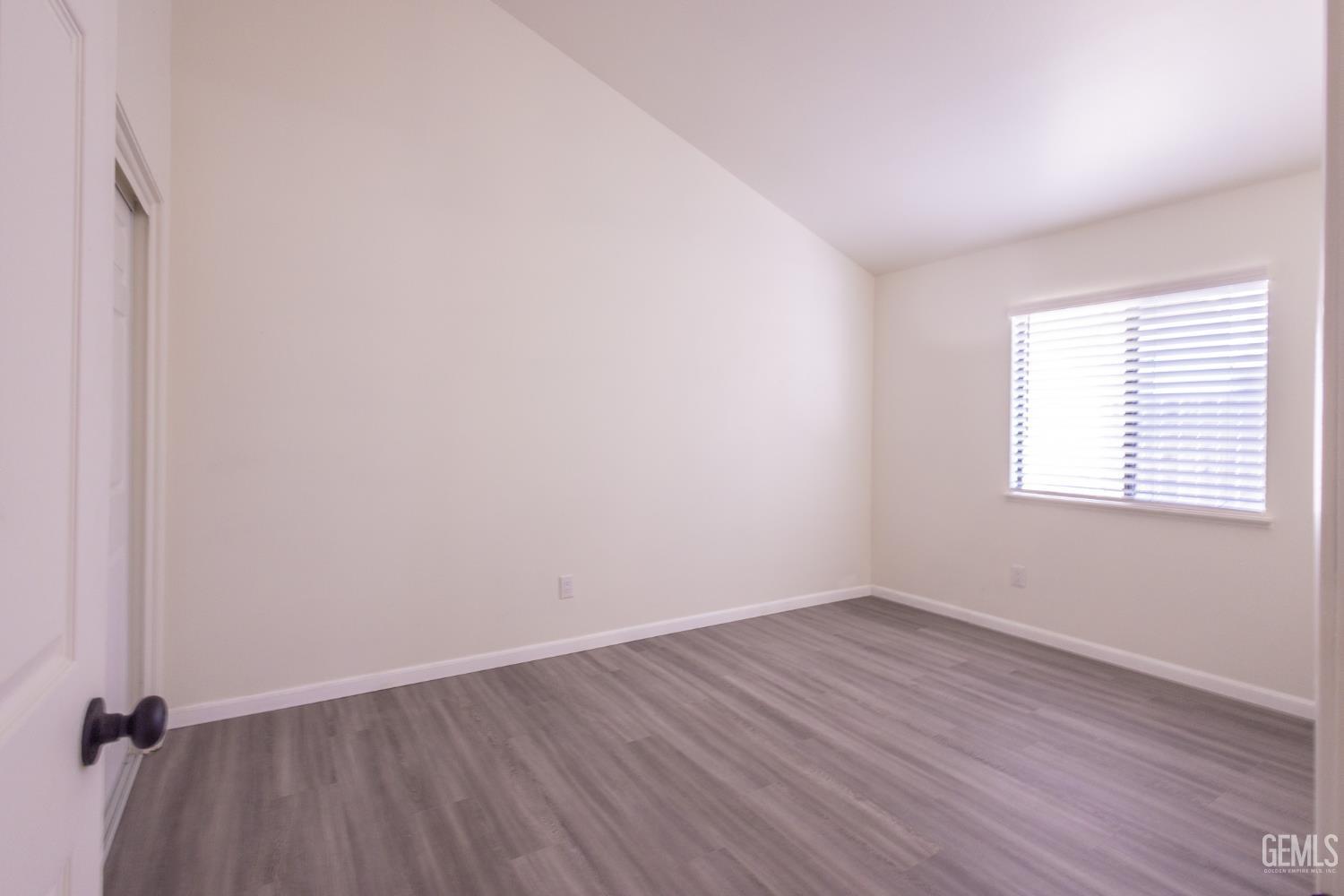 Undisclosed Address Bakersfield, CA 93309 - Photo 15 of 37 an empty room with wooden floor and windows