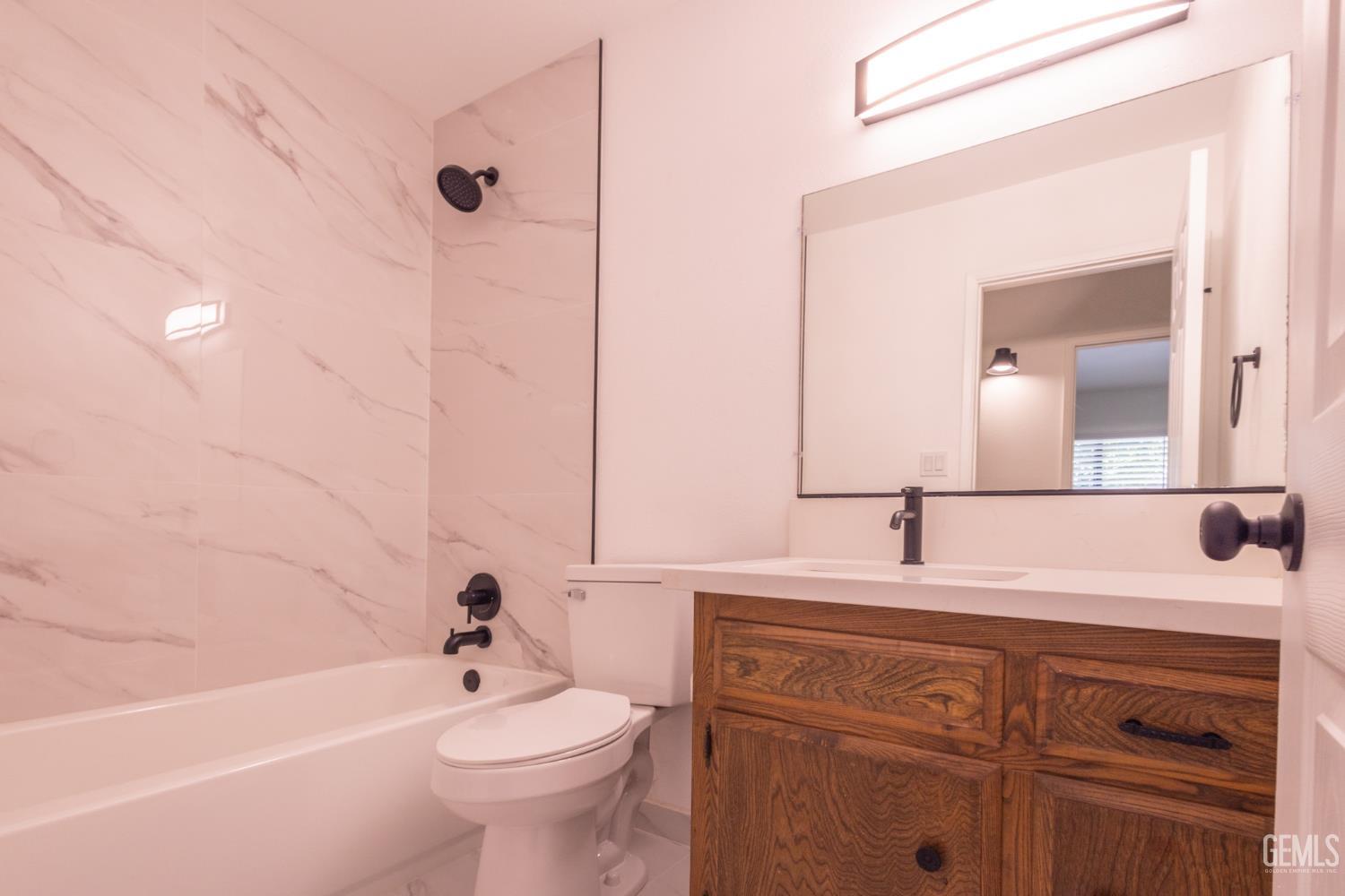 Undisclosed Address Bakersfield, CA 93309 - Photo 16 of 37 a bathroom with a sink a toilet and shower