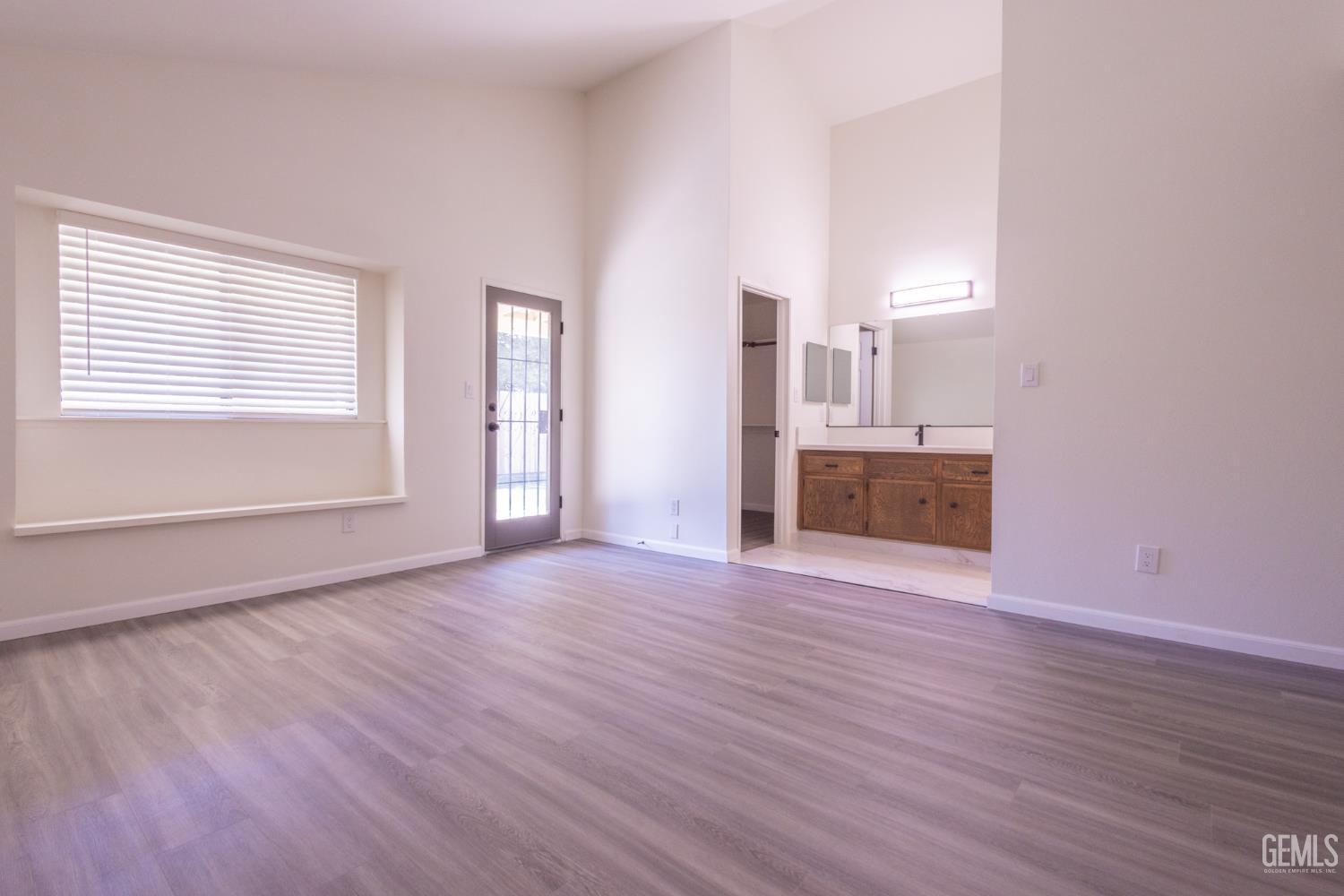 Undisclosed Address Bakersfield, CA 93309 - Photo 19 of 37 a view of empty room with wooden floor and window