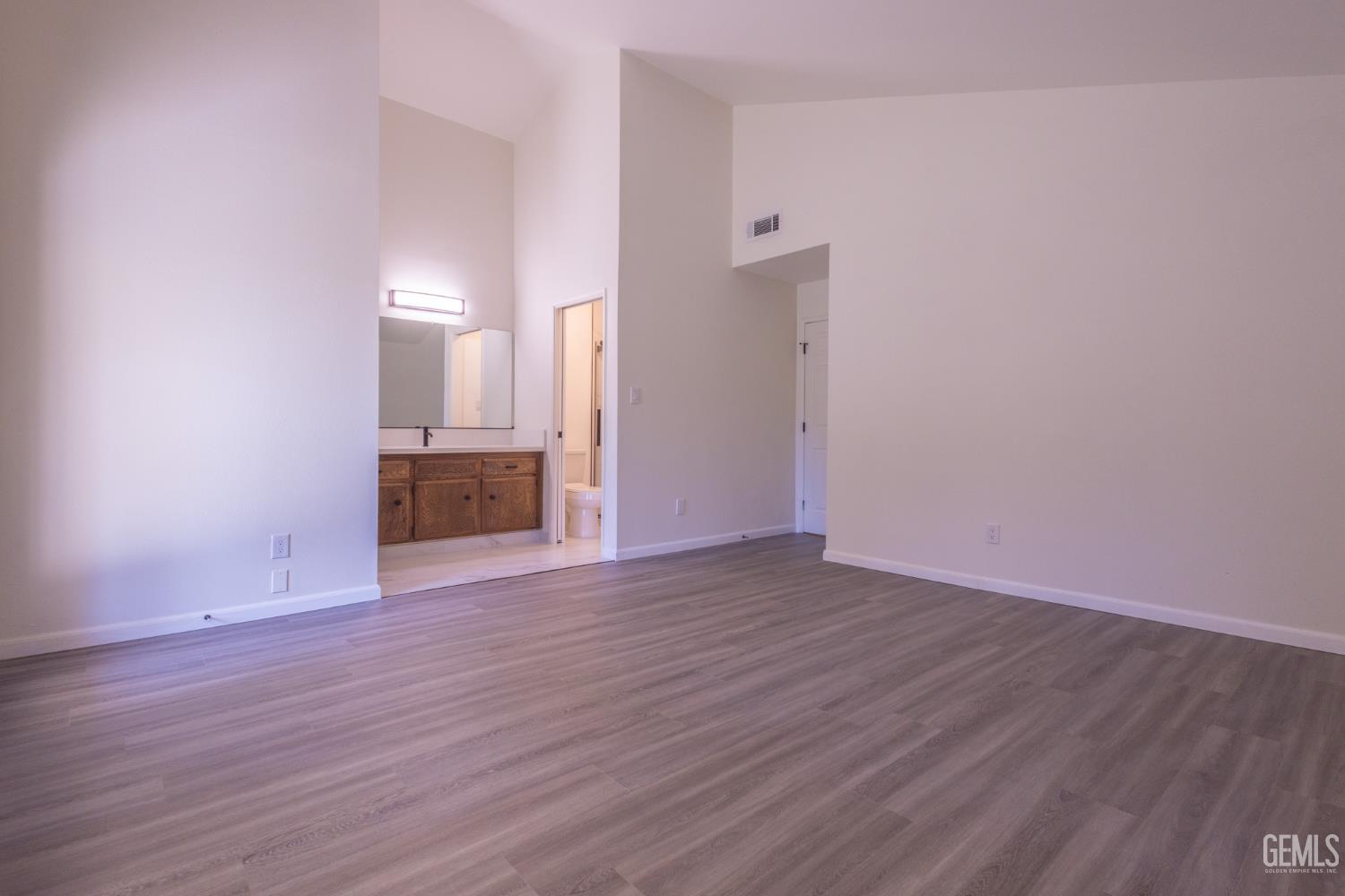 Undisclosed Address Bakersfield, CA 93309 - Photo 20 of 37 a view of empty room with wooden floor