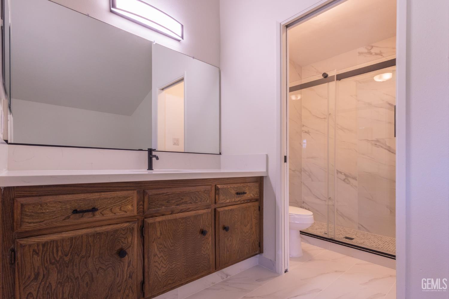 Undisclosed Address Bakersfield, CA 93309 - Photo 21 of 37 a bathroom with a sink and mirror