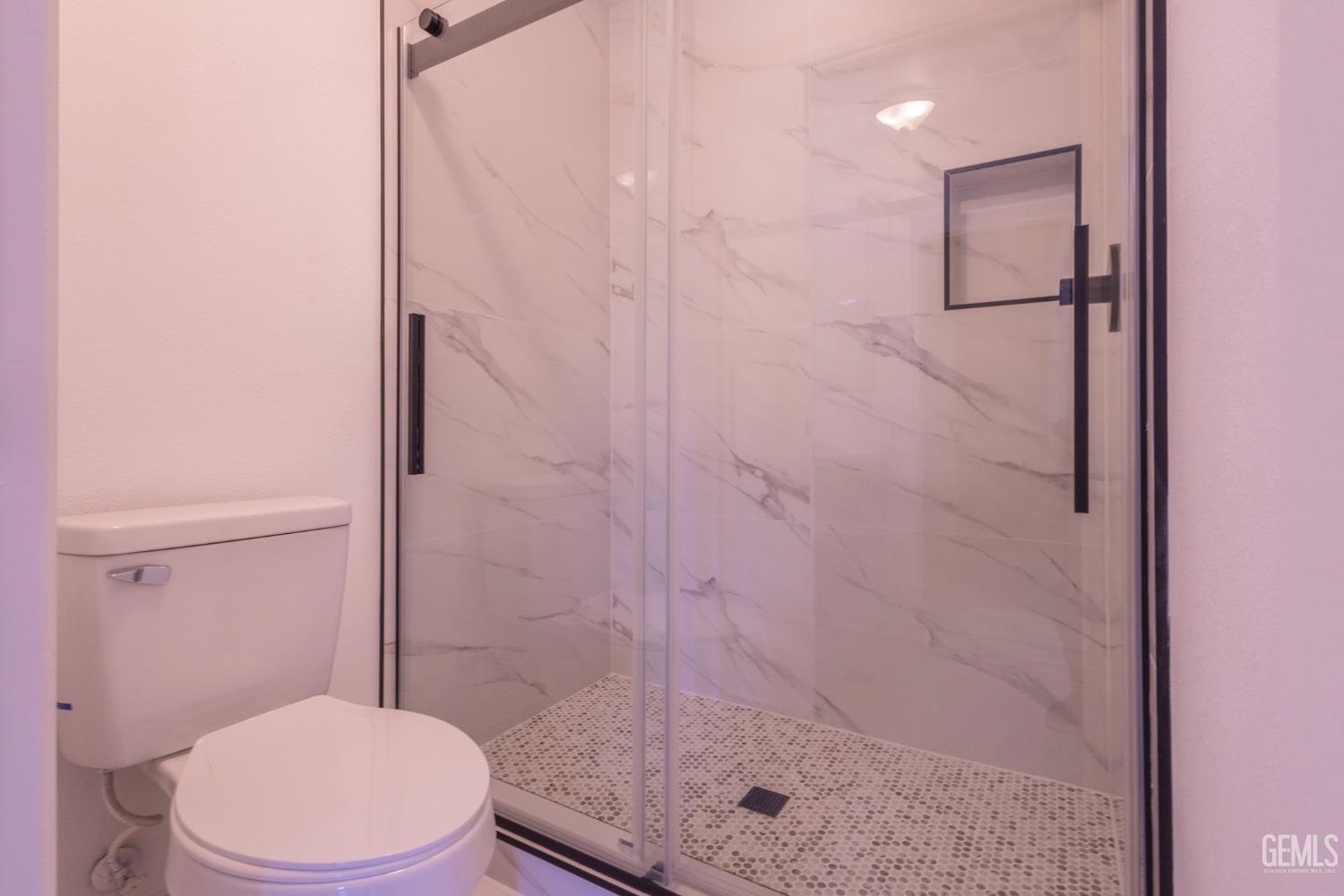 Undisclosed Address Bakersfield, CA 93309 - Photo 22 of 37 a white toilet next to a shower