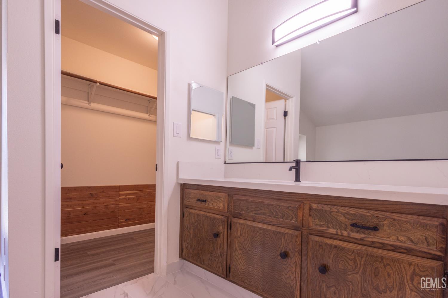 Undisclosed Address Bakersfield, CA 93309 - Photo 23 of 37 a bathroom with a sink and a mirror