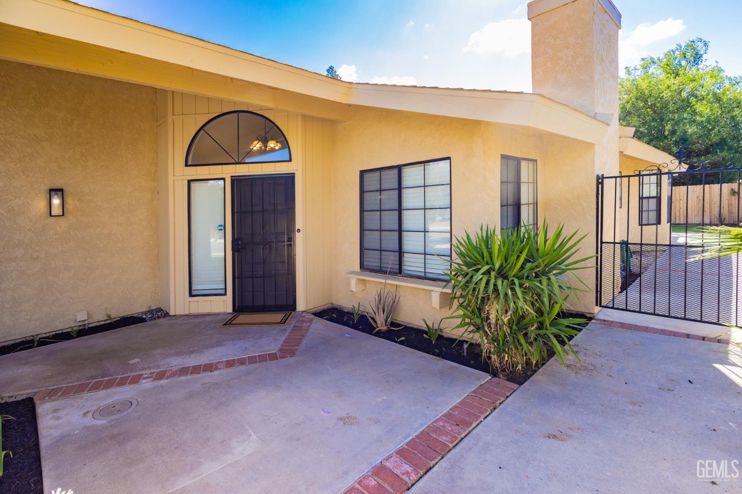 Undisclosed Address Bakersfield, CA 93309 - Photo 6 of 37 a front view of a house with garden