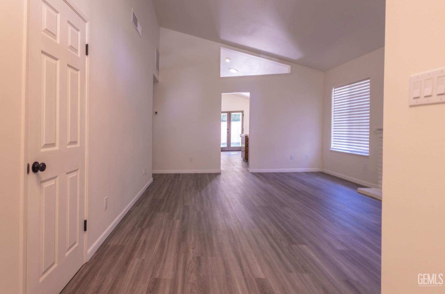 Undisclosed Address Bakersfield, CA 93309 - Photo 7 of 37 a view of empty room with window and wooden floor
