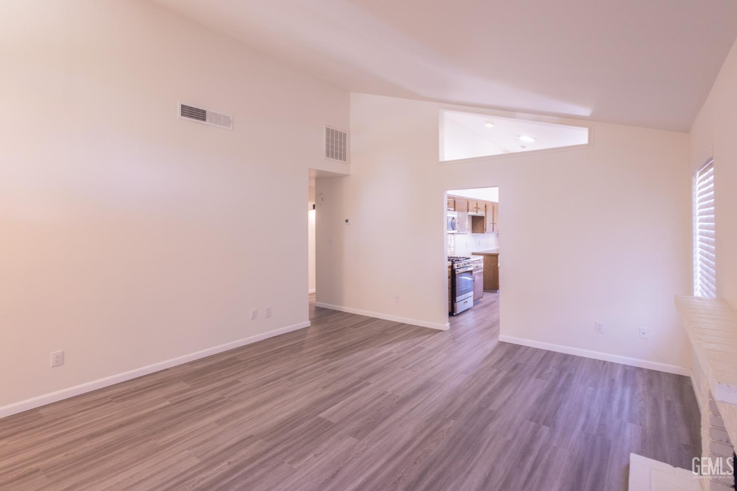 Undisclosed Address Bakersfield, CA 93309 - Photo 9 of 37 a view of empty room with wooden floor
