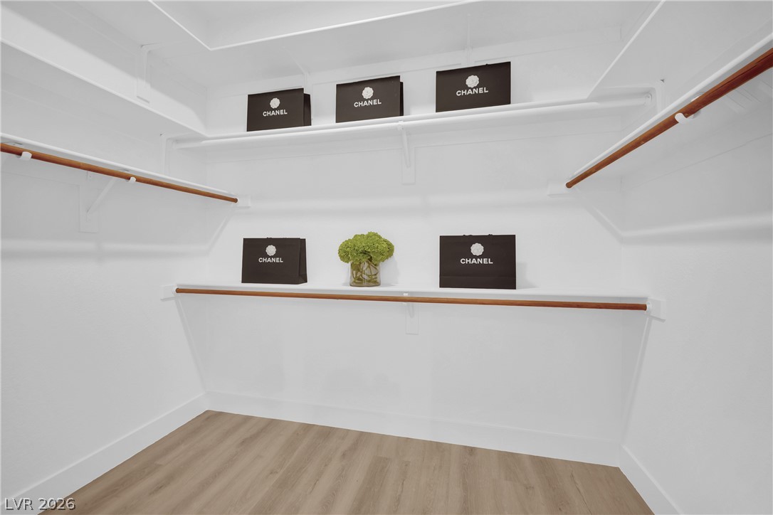 8981 Rivers Edge Drive Las Vegas, NV 89117 - Photo 35 of 69 Customizable storage solutions define this practical and well-lit walk-in closet.