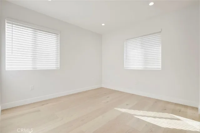 an empty room with windows and closet
