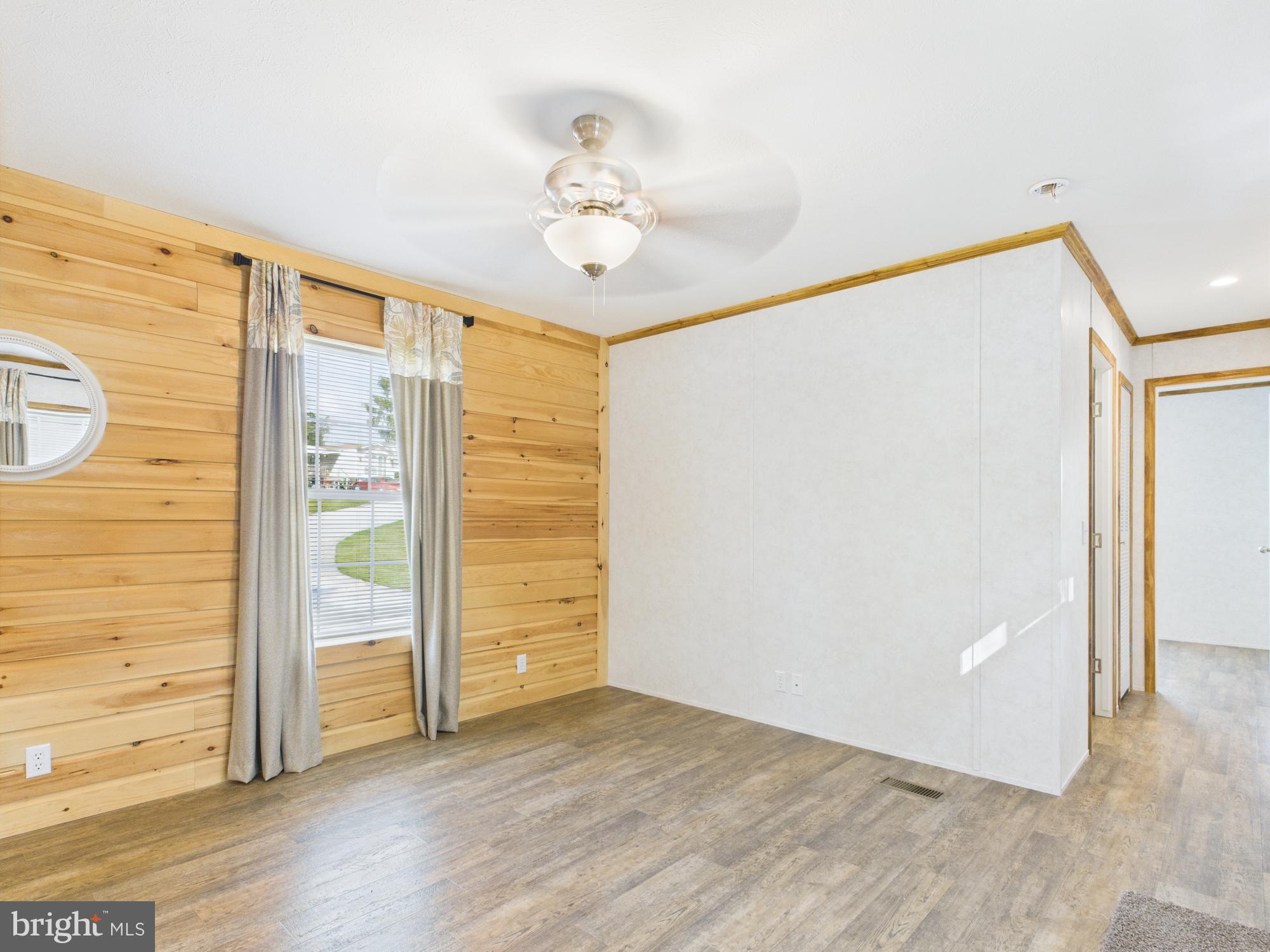 140 Rustique Drive York, PA 17408 - Photo 16 of 25 an empty room with wooden floor chandelier fan and windows