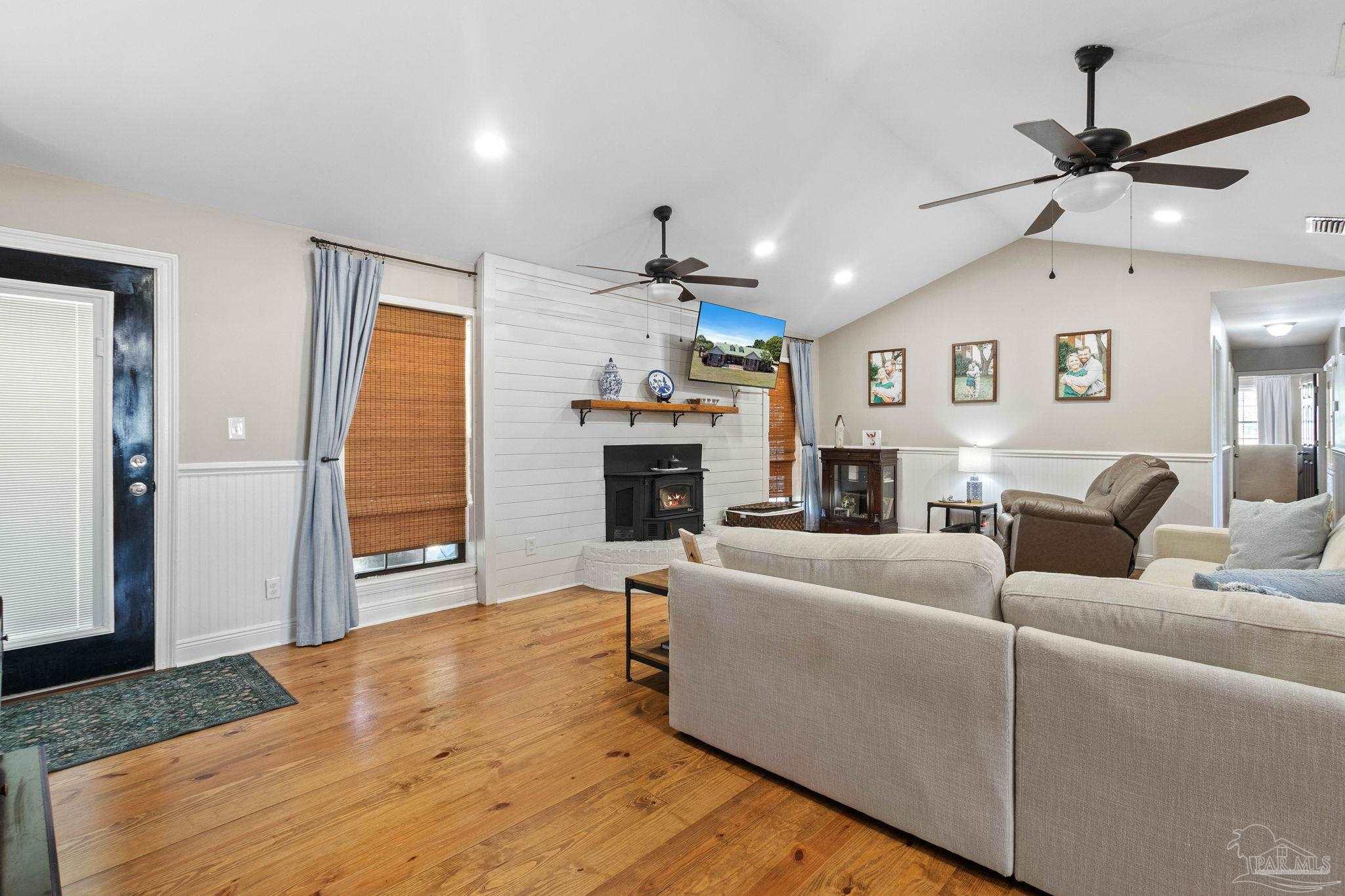 4349 Turkey Hollow Road Frisco City, AL 36445 - Photo 15 of 64 a living room with furniture a fireplace and wooden floor