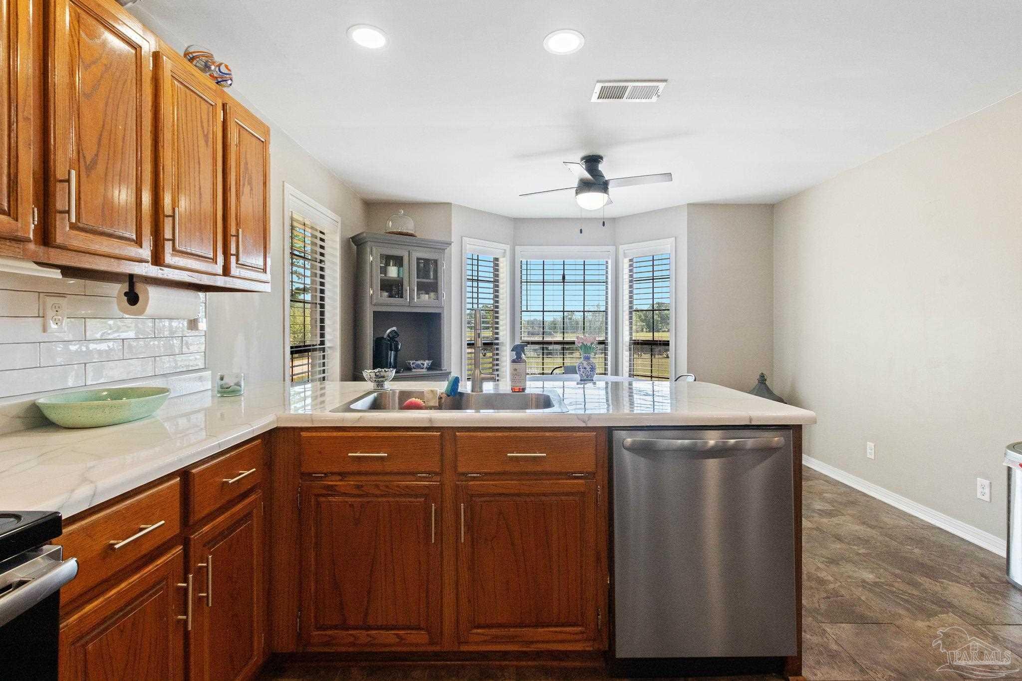 4349 Turkey Hollow Road Frisco City, AL 36445 - Photo 21 of 64 a kitchen with granite countertop cabinets and window
