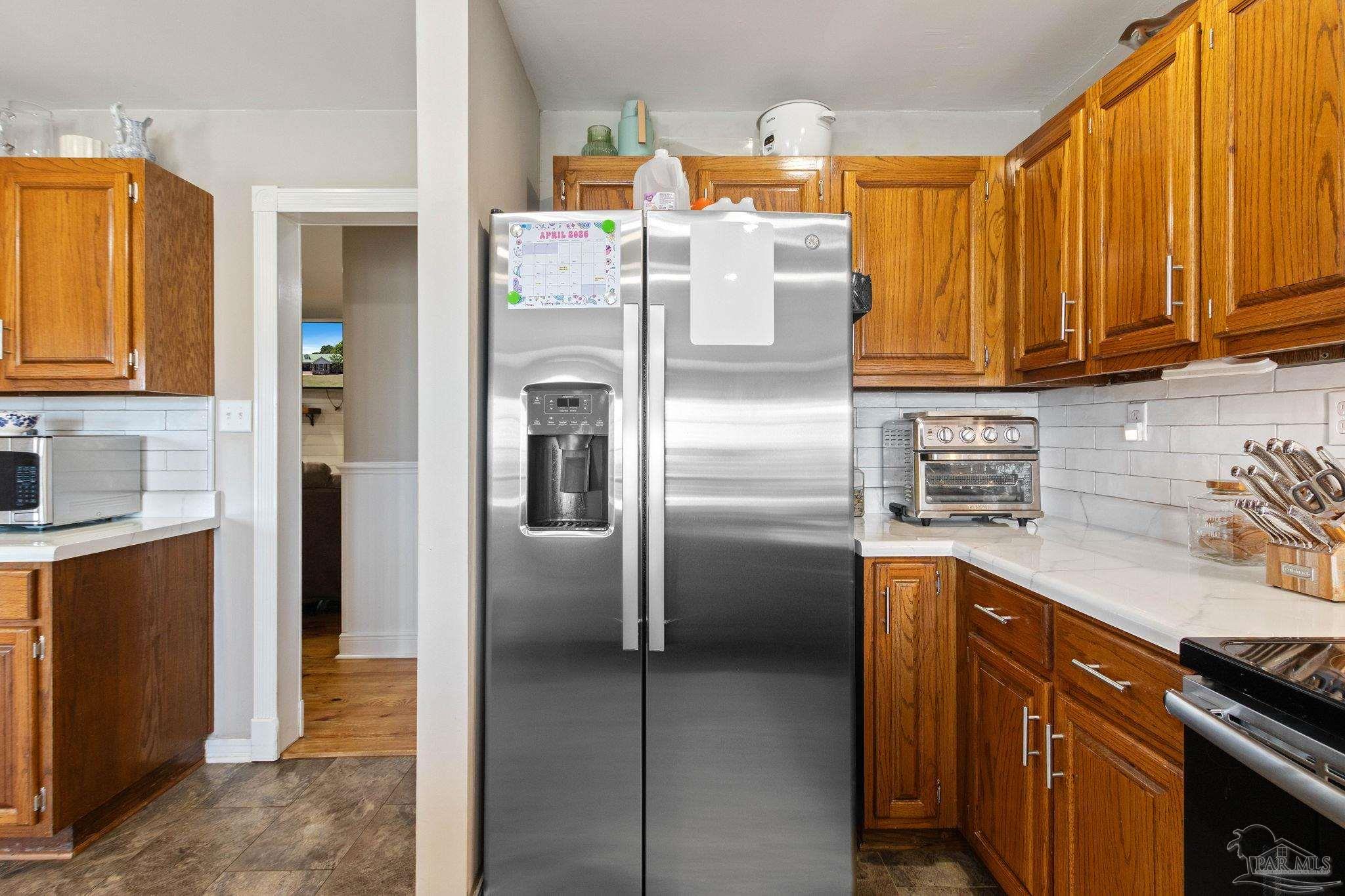 4349 Turkey Hollow Road Frisco City, AL 36445 - Photo 24 of 64 a kitchen with stainless steel appliances granite countertop a refrigerator and a stove top oven