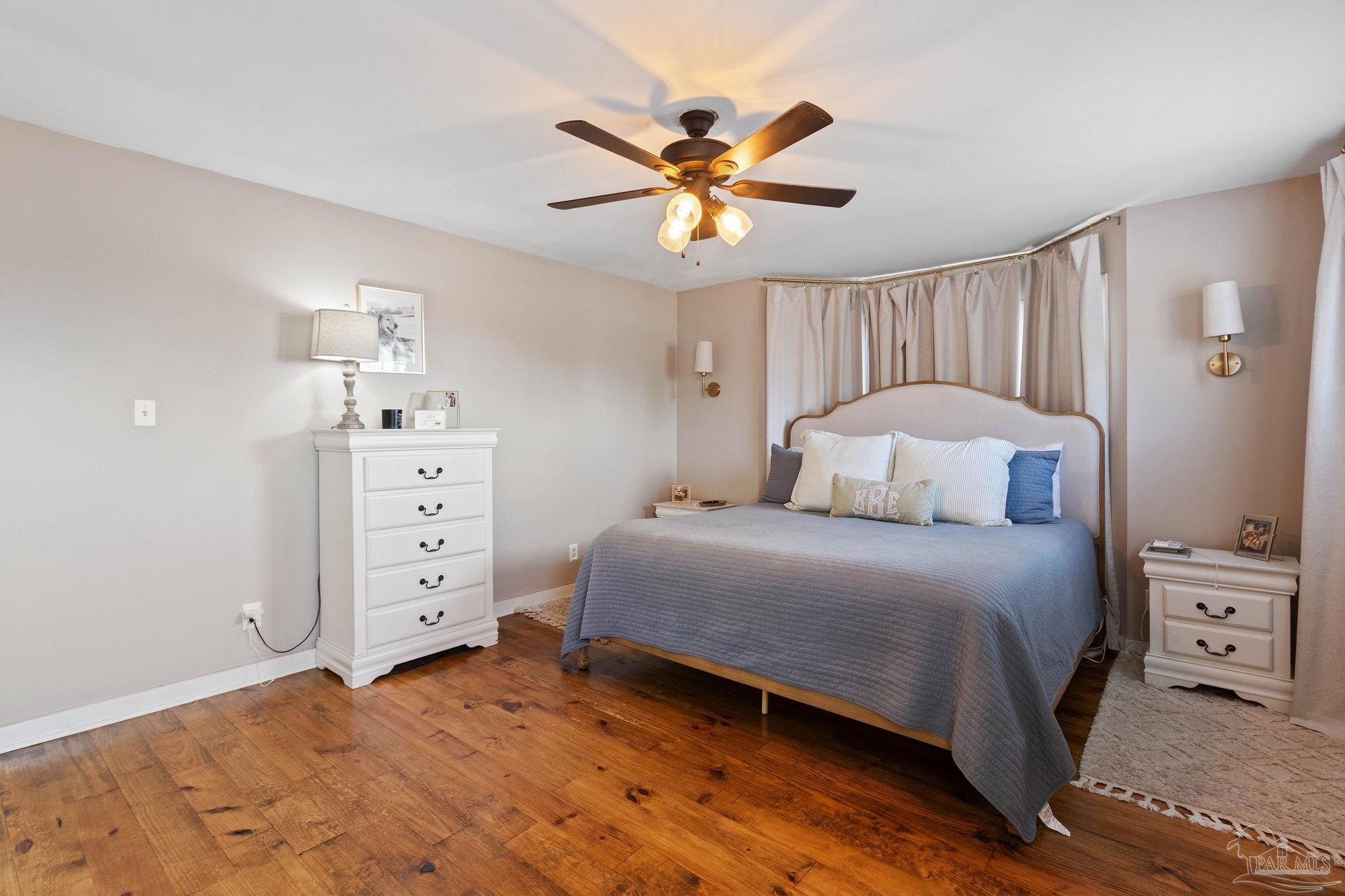 4349 Turkey Hollow Road Frisco City, AL 36445 - Photo 32 of 64 a bedroom with a bed and a chandelier