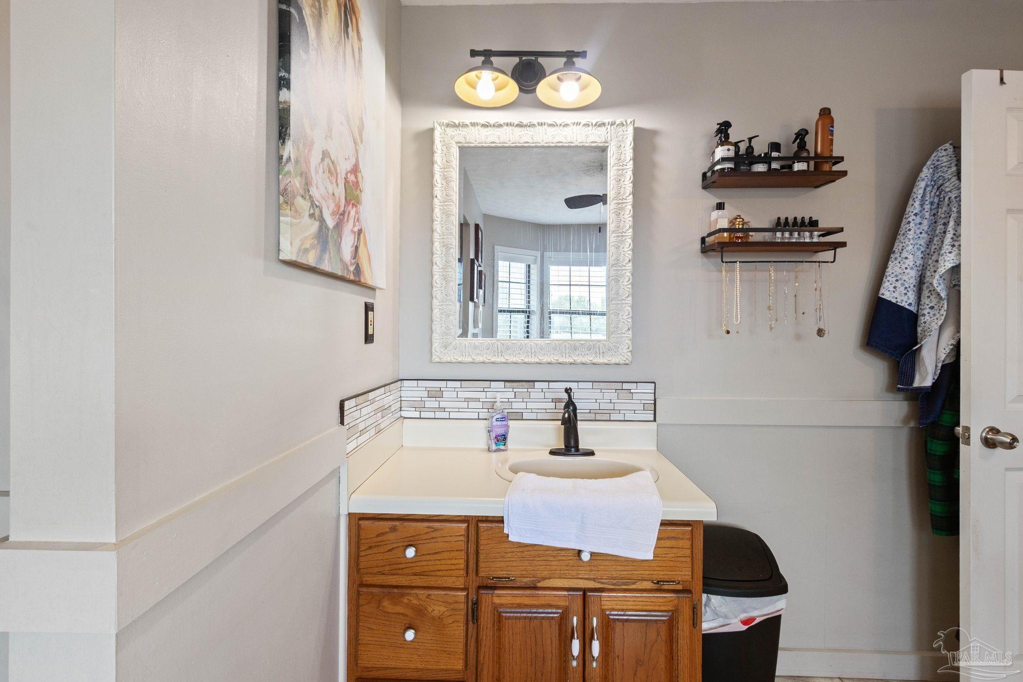 4349 Turkey Hollow Road Frisco City, AL 36445 - Photo 35 of 64 a bathroom with a sink and a mirror