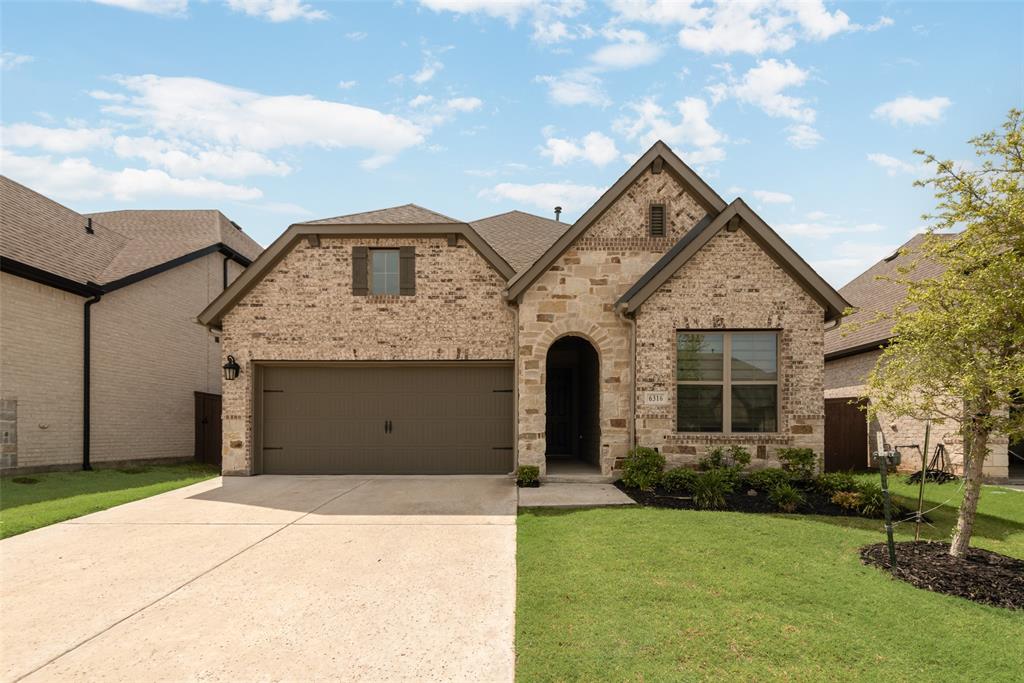 6316 Hedgecoxe Road The Colony, TX 75056 - Photo 1 of 1 a front view of a house with garden