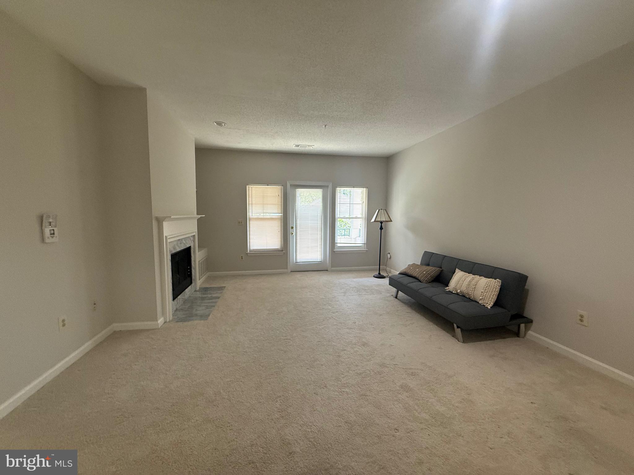 12012 Taliesin Place, Unit 24 Reston, VA 20190 - Photo 11 of 21 an empty room with windows and fireplace