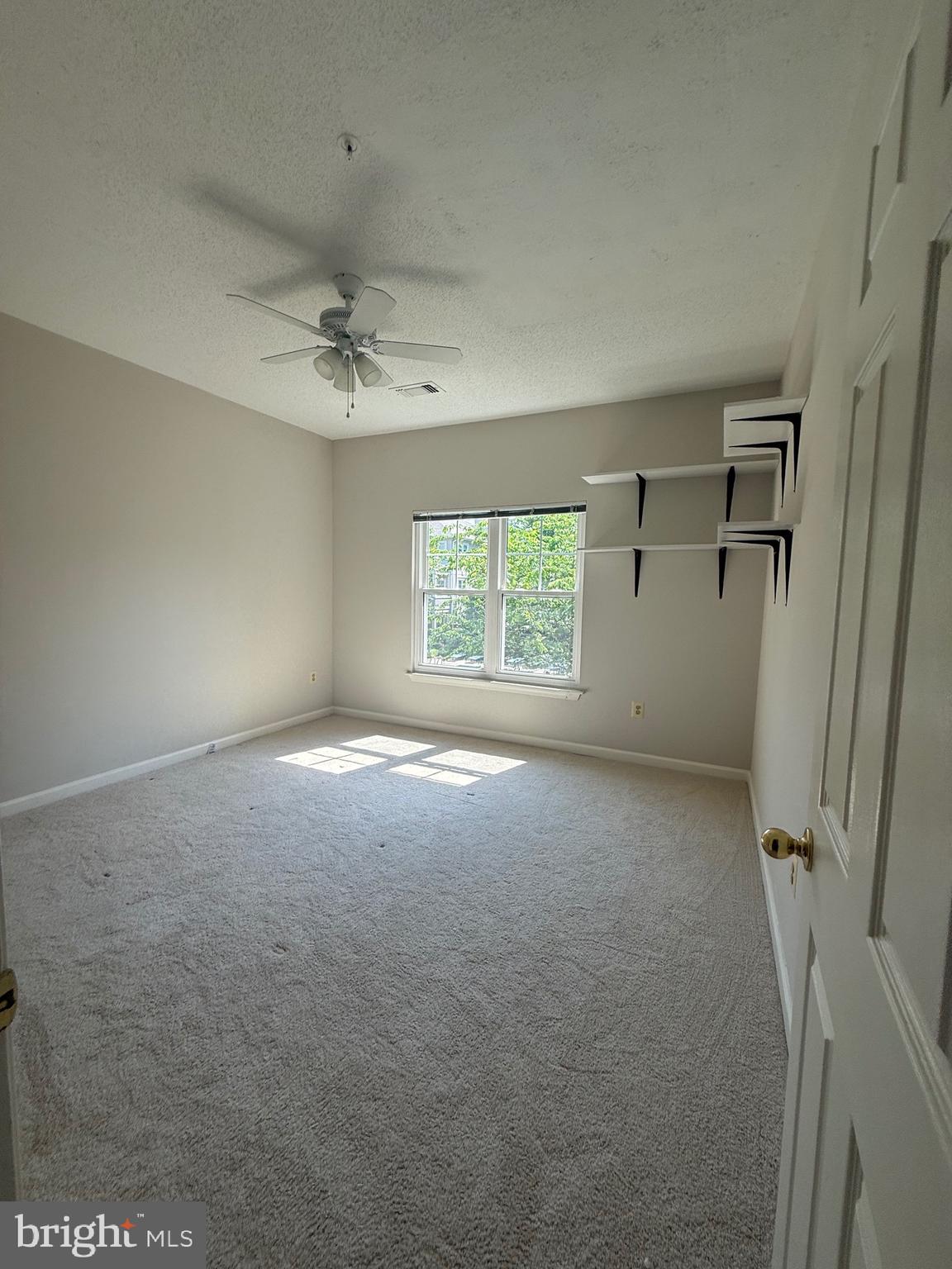 12012 Taliesin Place, Unit 24 Reston, VA 20190 - Photo 13 of 21 an empty room with a window and a ceiling fan