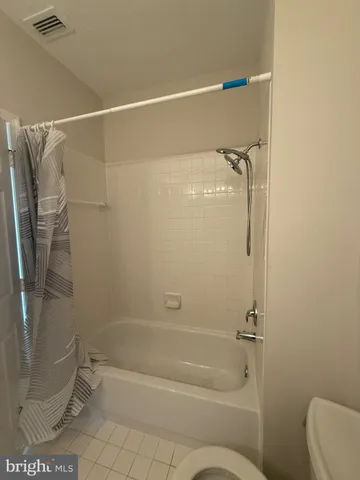 a bathroom with a shower and a toilet