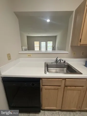 a kitchen with sink and cabinets