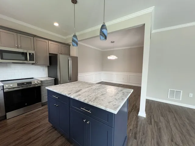 a kitchen with a stove and a refrigerator